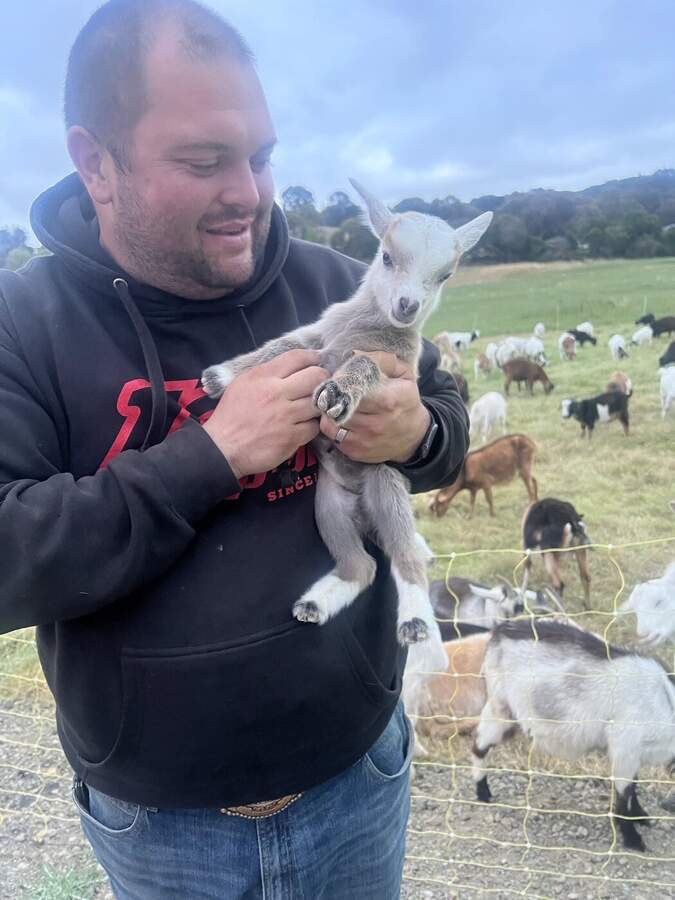 Herdsman with a baby goat